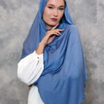 Dusty blue hijab styled elegantly with a soft drape.