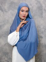 Dusty blue hijab styled elegantly with a soft drape.