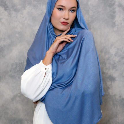 Dusty blue hijab styled elegantly with a soft drape.