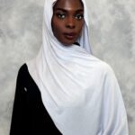 Elegant snow-white hijab styled gracefully with a smooth drape.