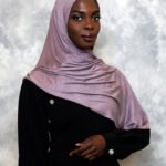 Shiny mauve satin hijab with soft lavender undertones, styled in an elegant drape.
