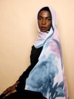 Luxury chiffon hijab in lilac with oversized blue floral design and elegant drape.