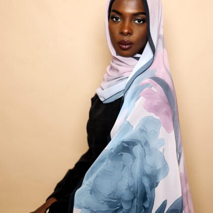 Luxury chiffon hijab in lilac with oversized blue floral design and elegant drape.
