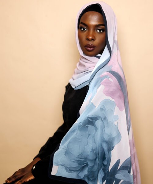Luxury chiffon hijab in lilac with oversized blue floral design and elegant drape.